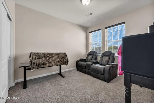 a view of a room with furniture and a window