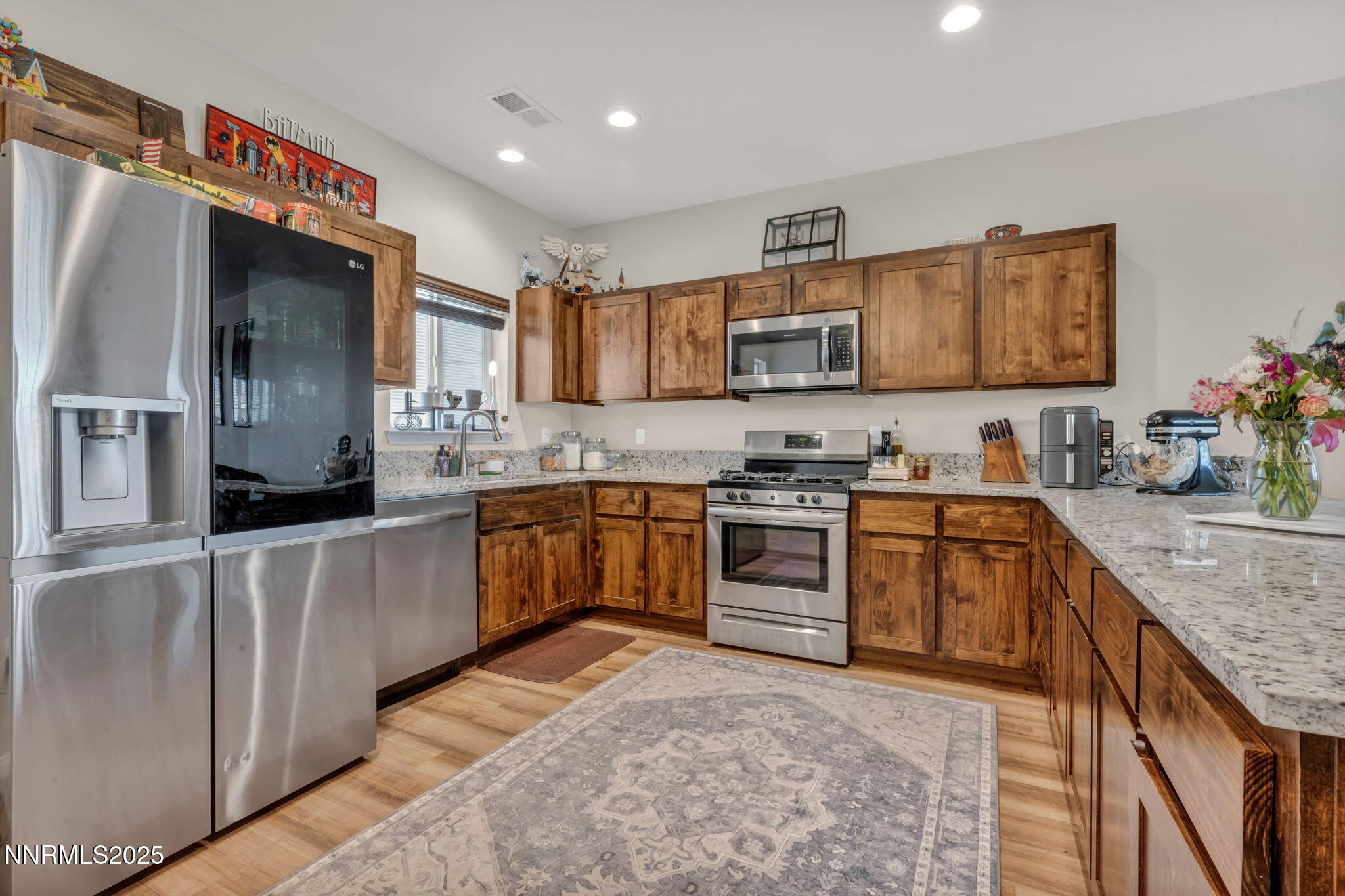 665 Beeghly Drive Fallon, NV 89406 - Photo 3 of 31 a kitchen with stainless steel appliances granite countertop a refrigerator sink and stove