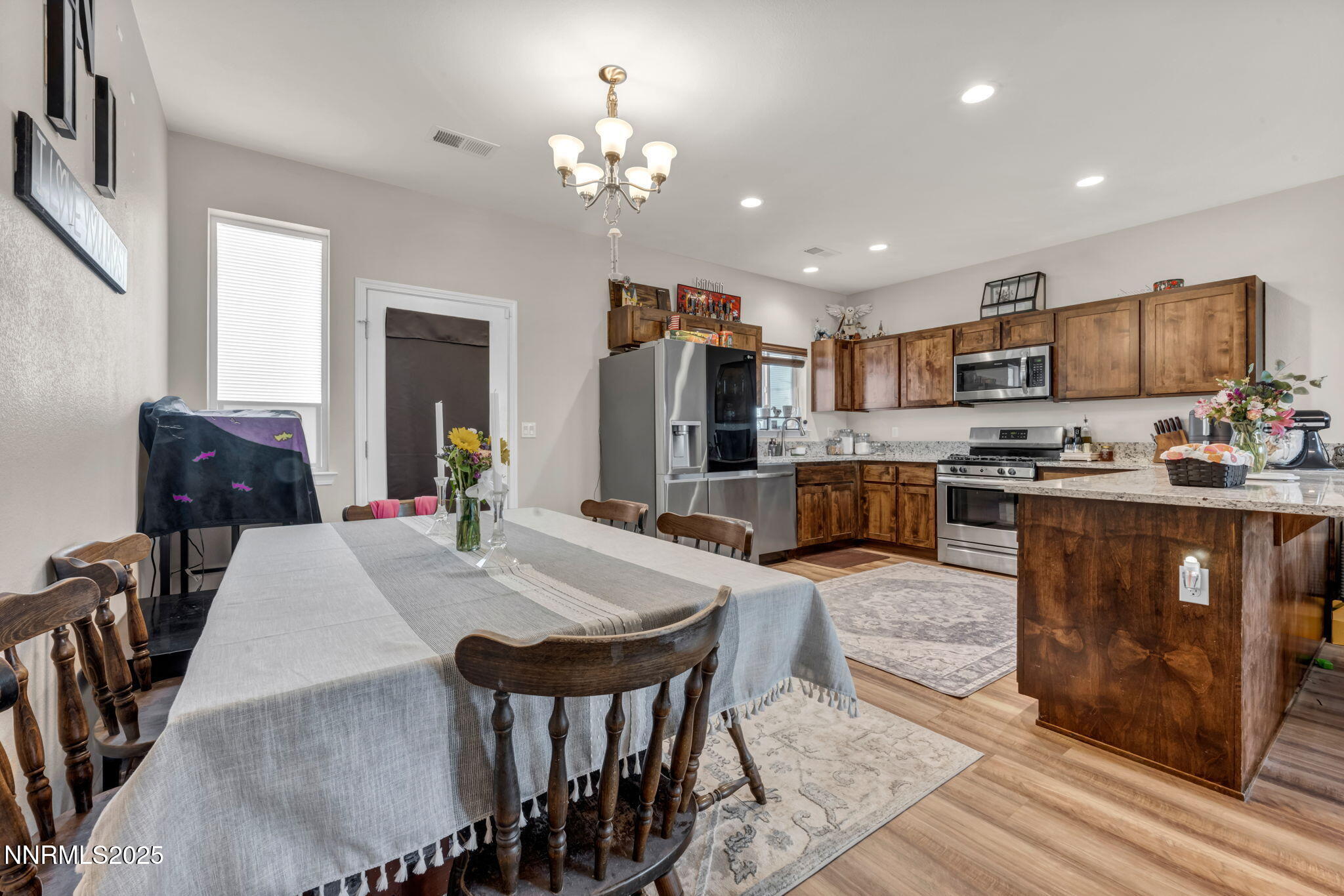 665 Beeghly Drive Fallon, NV 89406 - Photo 6 of 31 a open kitchen with stainless steel appliances granite countertop a stove a refrigerator a kitchen island a table and chairs