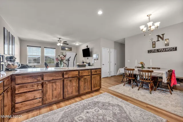 a living room with furniture a dining table and a refrigerator