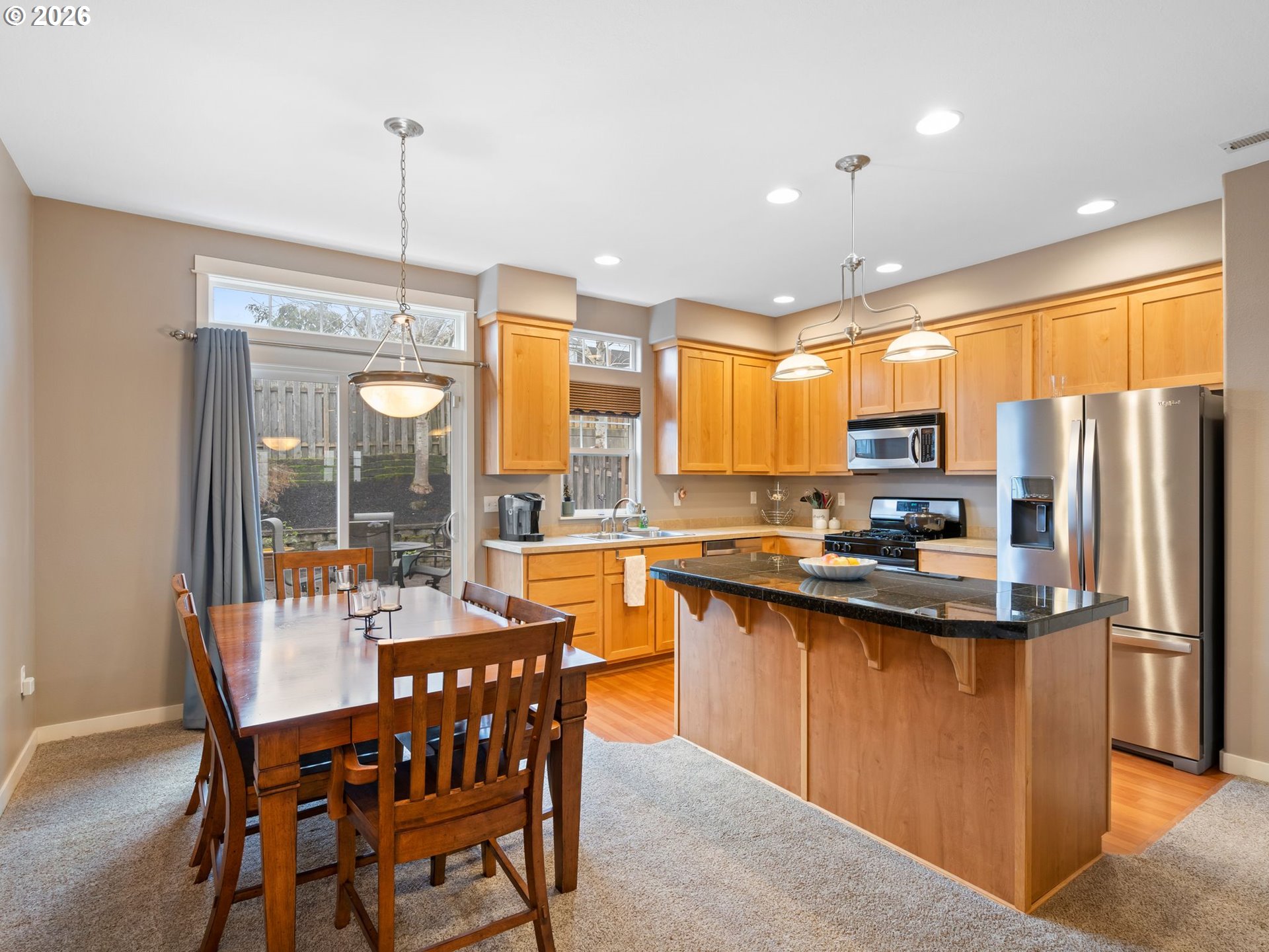 2513 Northwest 3rd Terrace Gresham, OR 97030 - Photo 12 of 38 a kitchen with refrigerator a stove and wooden floor