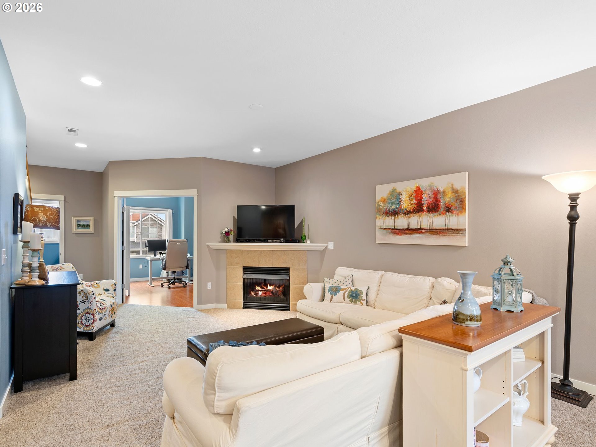 2513 Northwest 3rd Terrace Gresham, OR 97030 - Photo 14 of 38 a living room with furniture a flat screen tv and a fireplace