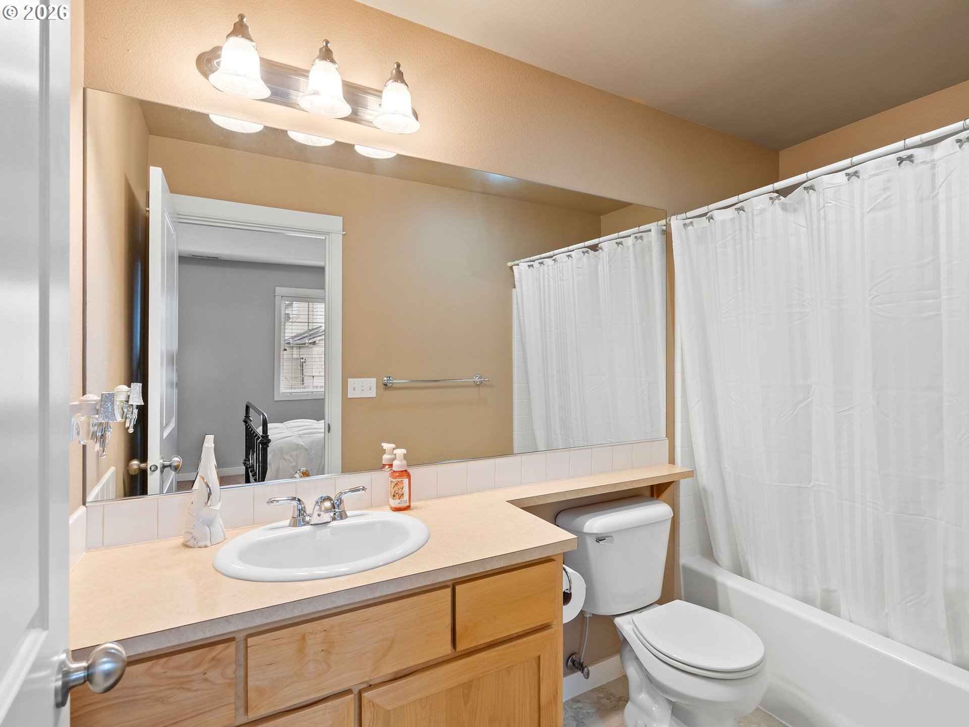 2513 Northwest 3rd Terrace Gresham, OR 97030 - Photo 24 of 38 a bathroom with a sink a toilet a mirror and shower curtain