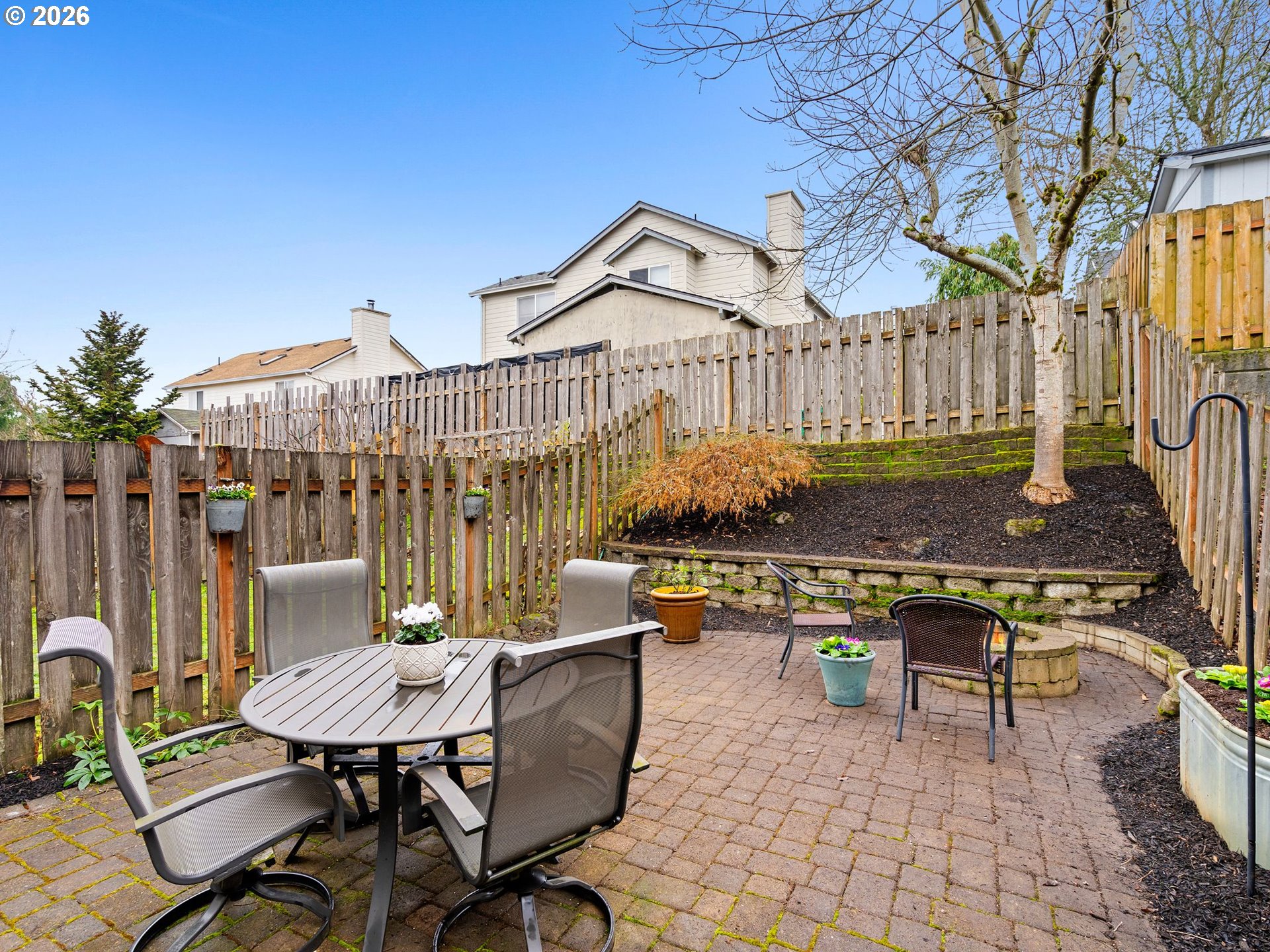 2513 Northwest 3rd Terrace Gresham, OR 97030 - Photo 32 of 38 a view of a patio with table and chairs with wooden fence and plants