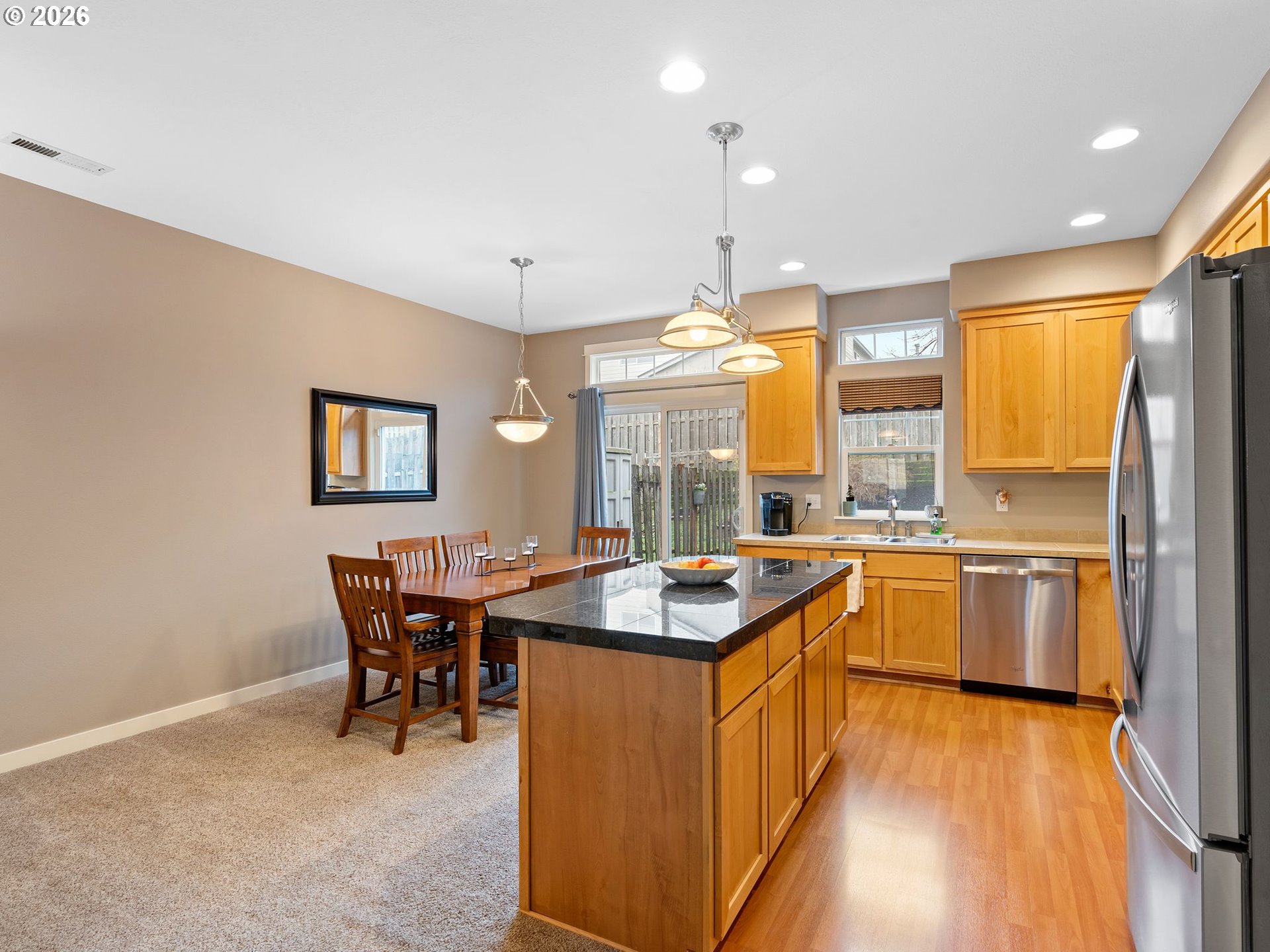 2513 Northwest 3rd Terrace Gresham, OR 97030 - Photo 9 of 38 a kitchen with stainless steel appliances granite countertop a sink a stove and a refrigerator