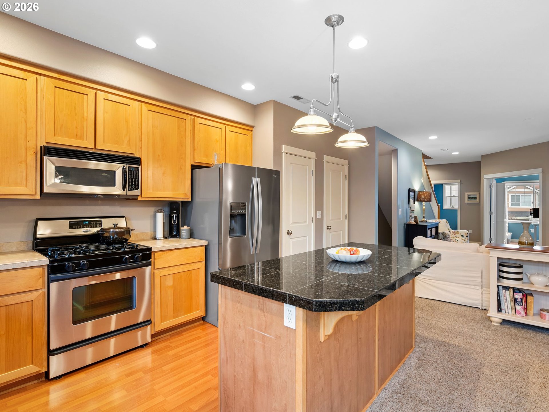 2513 Northwest 3rd Terrace Gresham, OR 97030 - Photo 10 of 38 a kitchen with stainless steel appliances granite countertop a stove a refrigerator a kitchen island a stove and a sink