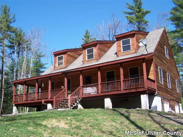 618 Buck Road, Unit HOME ON 3 ACRES Stone Ridge, NY 12484 - Photo 1 of 1 a front view of a house with a yard