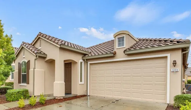 a front view of a house with garden