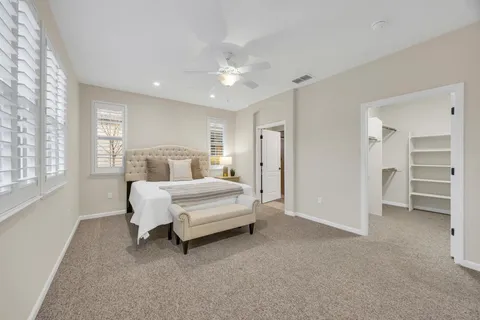 a bedroom with a large bed and a flat screen tv