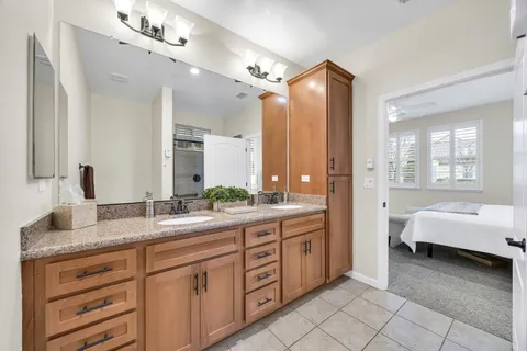 a bathroom with a shower sink and mirror
