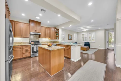 a kitchen with granite countertop stainless steel appliances and wooden cabinets