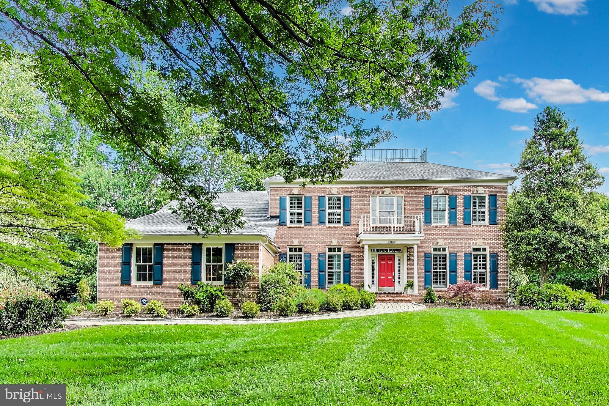 10106 Waterside Drive Burke, VA 22015 - Photo 1 of 30 a front view of a house with a garden