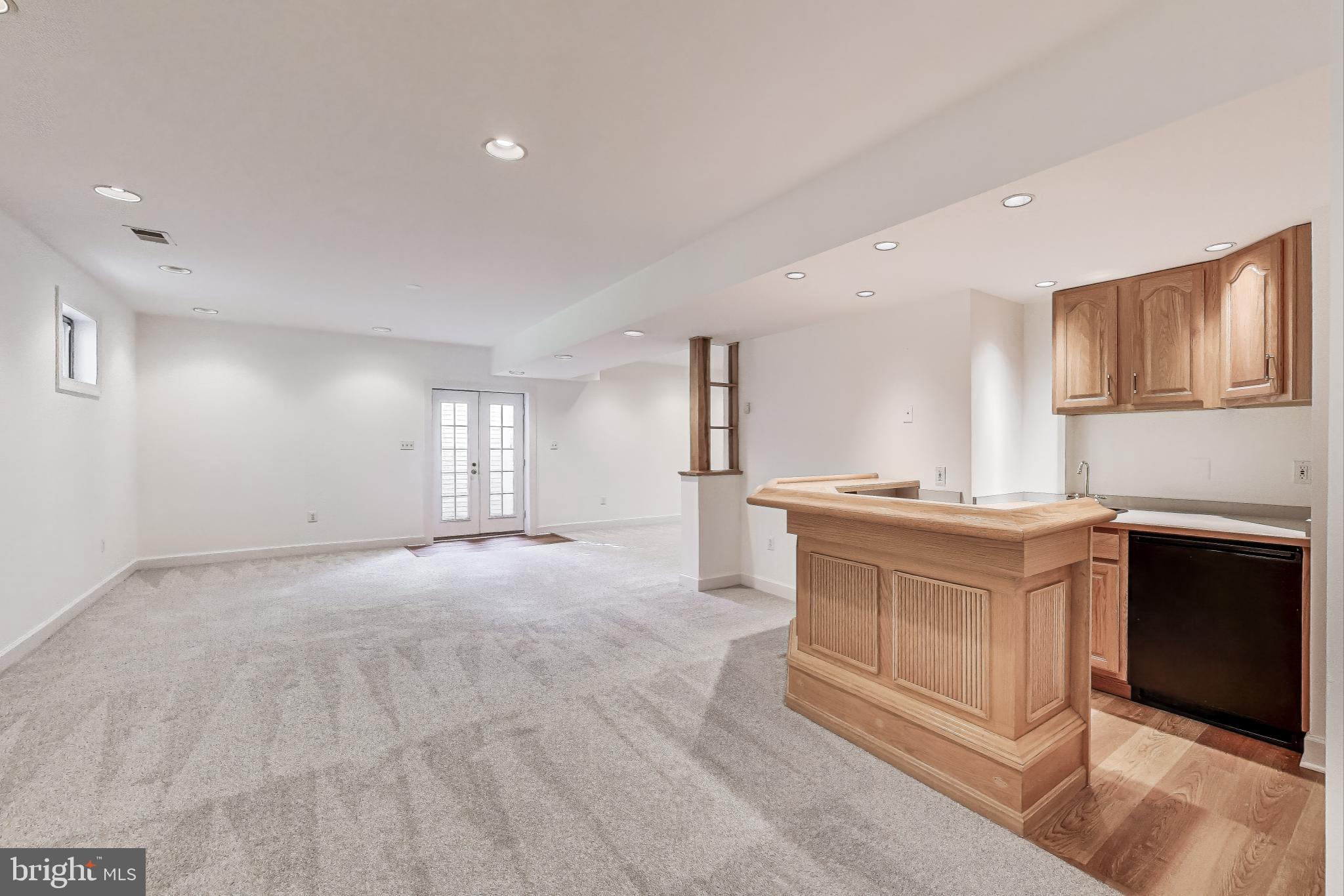 10106 Waterside Drive Burke, VA 22015 - Photo 21 of 30 a large white kitchen with granite countertop a stove top oven a sink and dishwasher