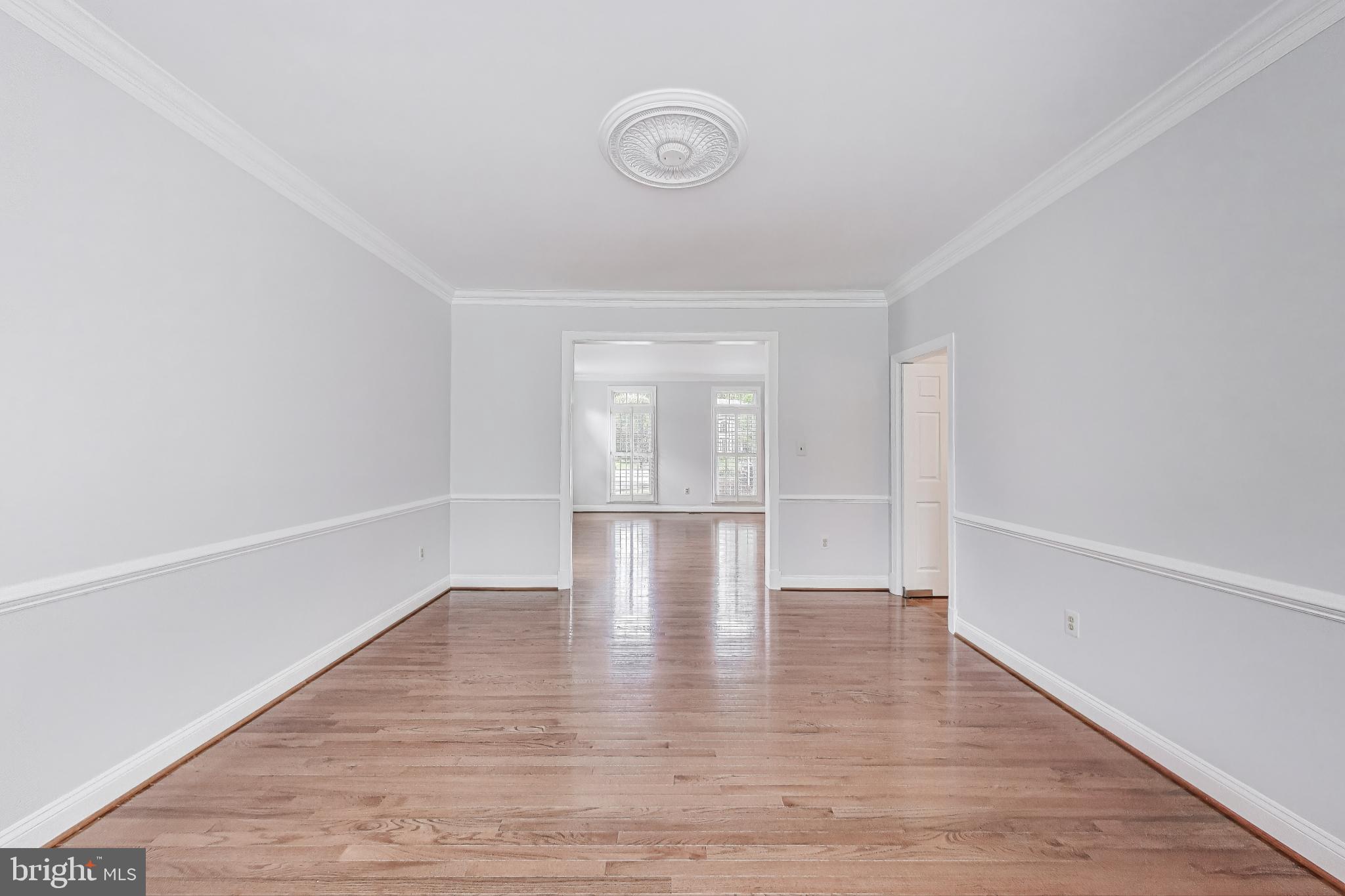 10106 Waterside Drive Burke, VA 22015 - Photo 4 of 30 a view of empty room with wooden floor and fan