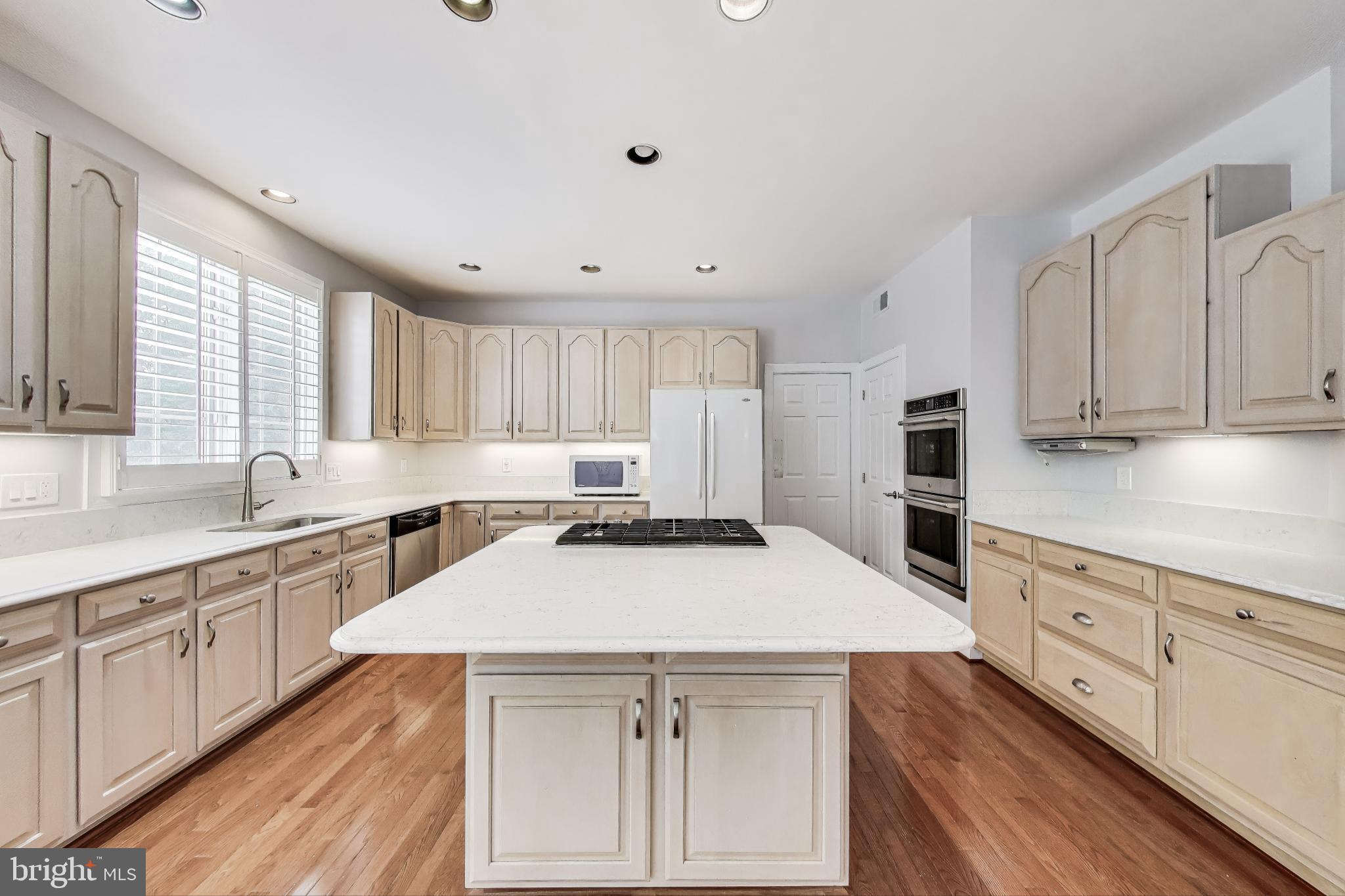 10106 Waterside Drive Burke, VA 22015 - Photo 7 of 30 a kitchen with granite countertop a sink stove and refrigerator
