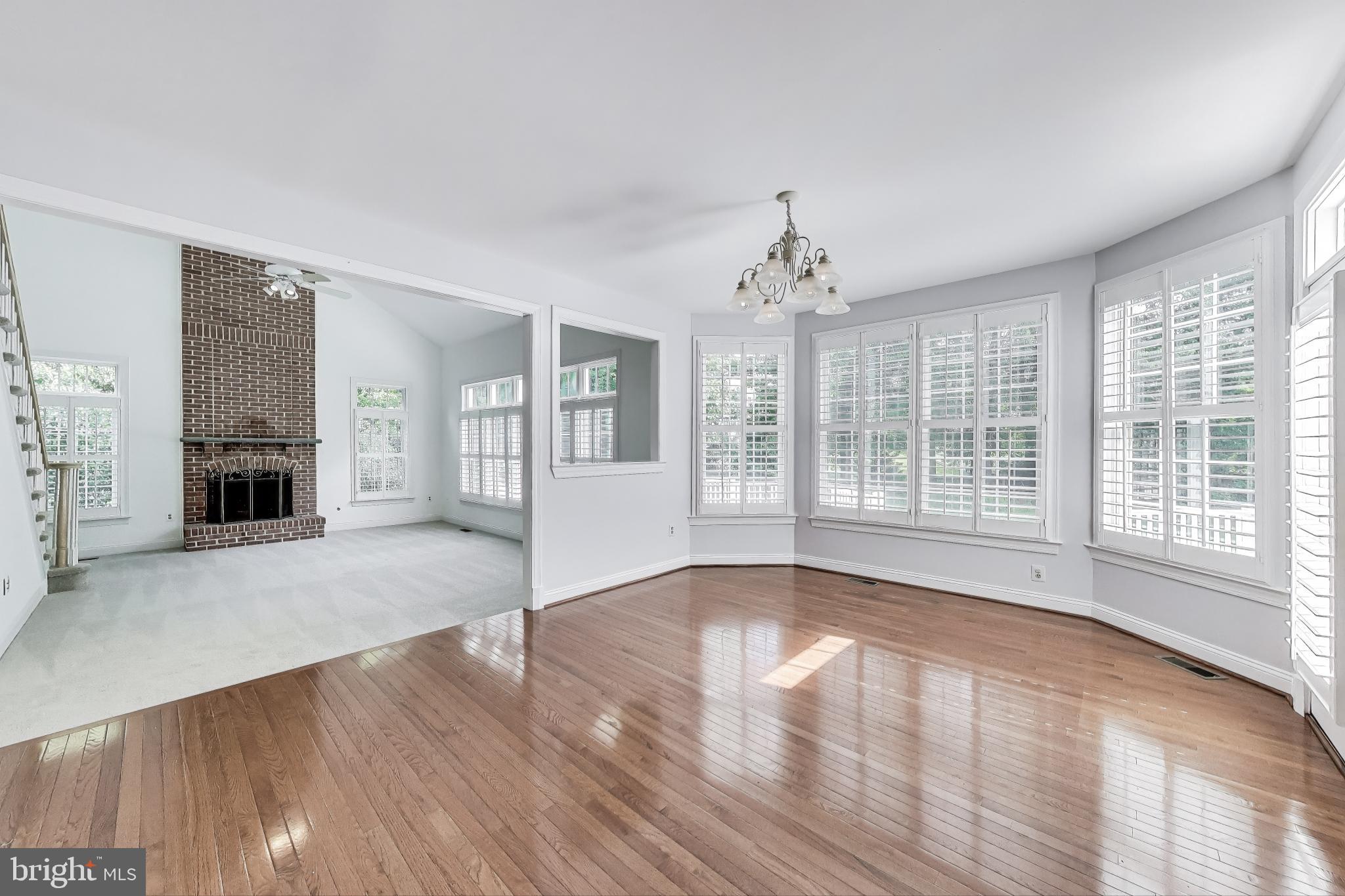 10106 Waterside Drive Burke, VA 22015 - Photo 8 of 30 a view of an empty room with wooden floor and a window