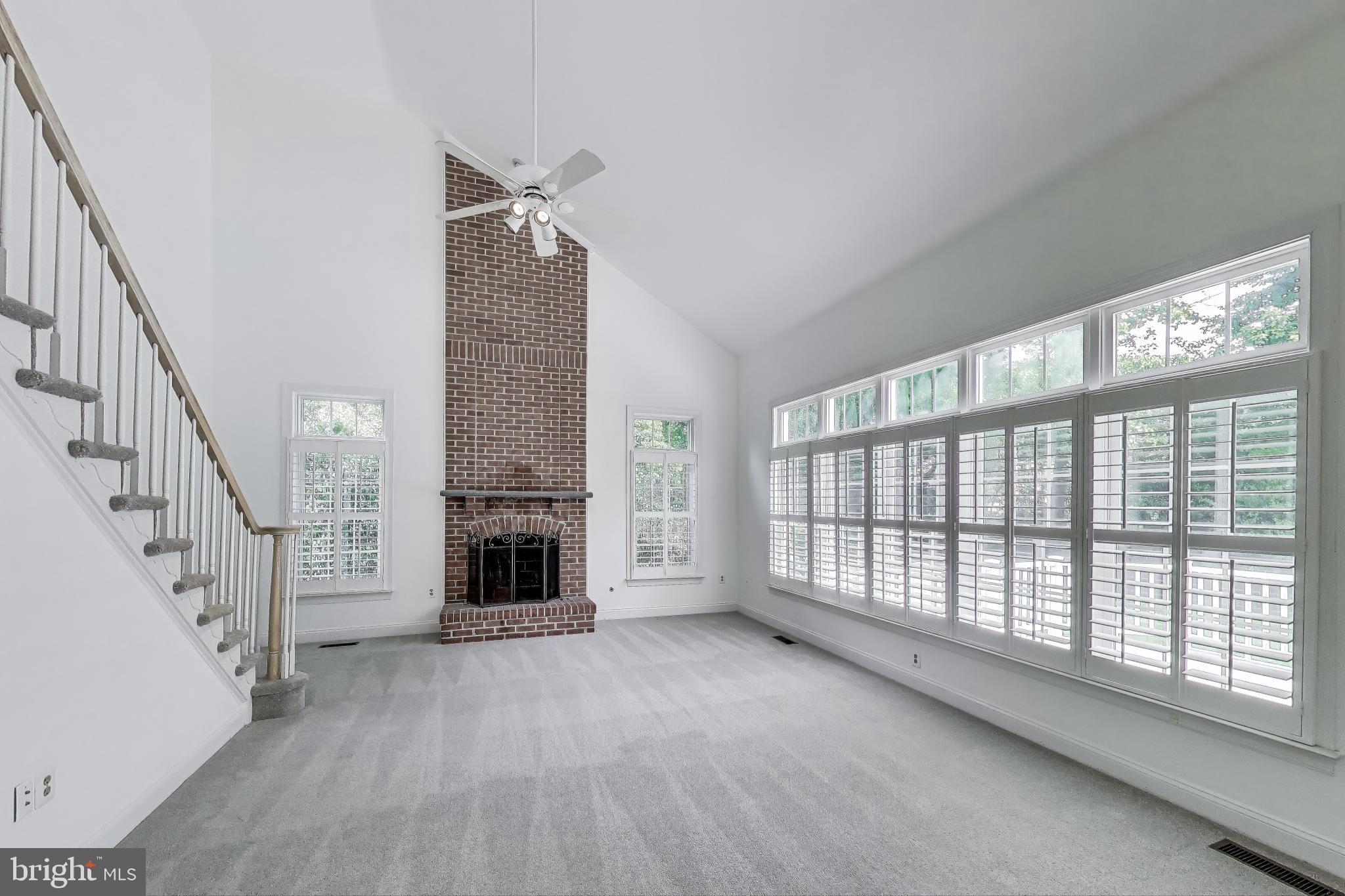 10106 Waterside Drive Burke, VA 22015 - Photo 9 of 30 a view of an empty room with fireplace and windows