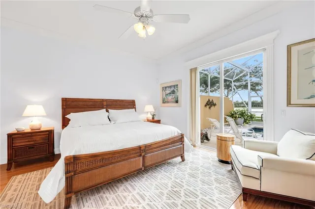a bedroom with a large bed and a chandelier
