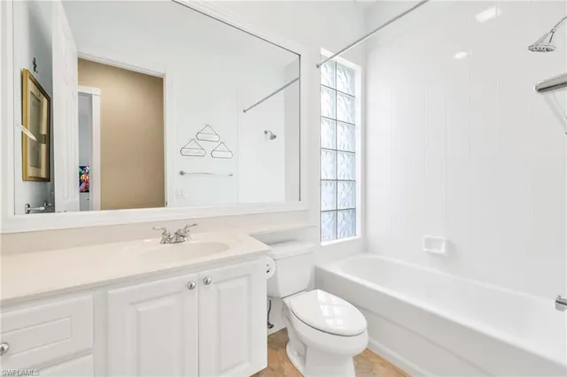 a sink with white cabinets