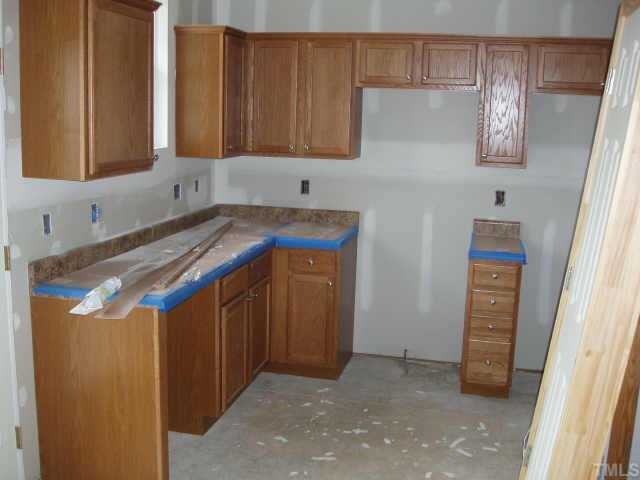 844 Horton Road, Unit 69 Durham, NC 27704 - Photo 4 of 5 a kitchen with a refrigerator and cabinets