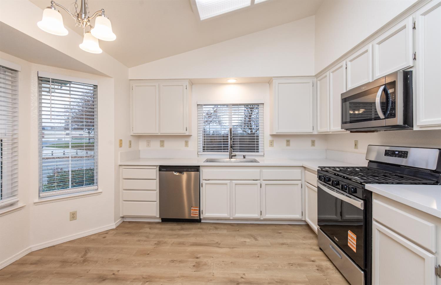 8245 Calleystone Way Antelope, CA 95843 - Photo 11 of 33 a kitchen with stainless steel appliances granite countertop a stove a sink and a microwave