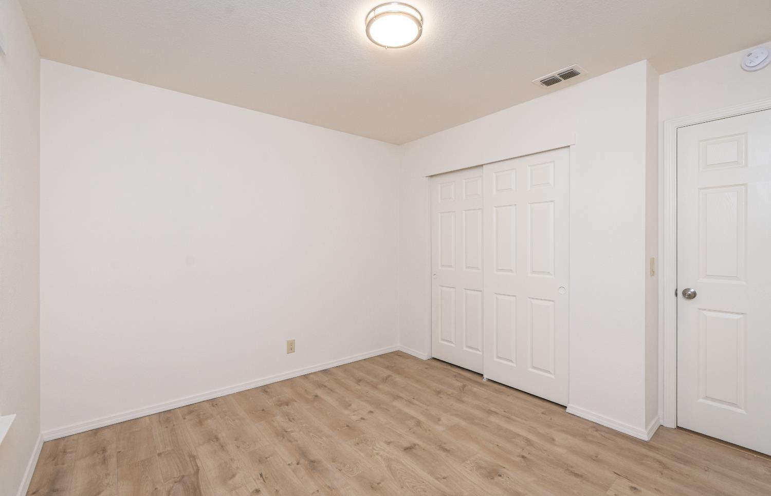 8245 Calleystone Way Antelope, CA 95843 - Photo 17 of 33 a view of a room with wooden floor
