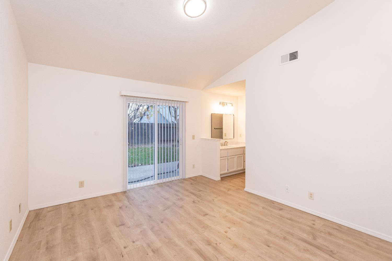 8245 Calleystone Way Antelope, CA 95843 - Photo 21 of 33 a view of an empty room with wooden floor and a window