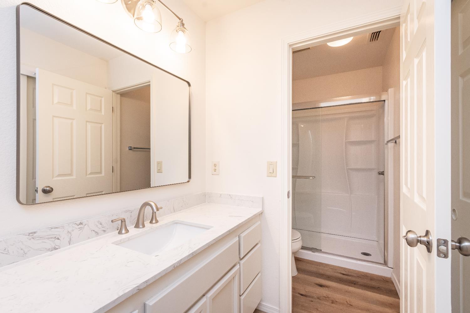 8245 Calleystone Way Antelope, CA 95843 - Photo 25 of 33 a bathroom with a bathtub shower sink vanity and mirror