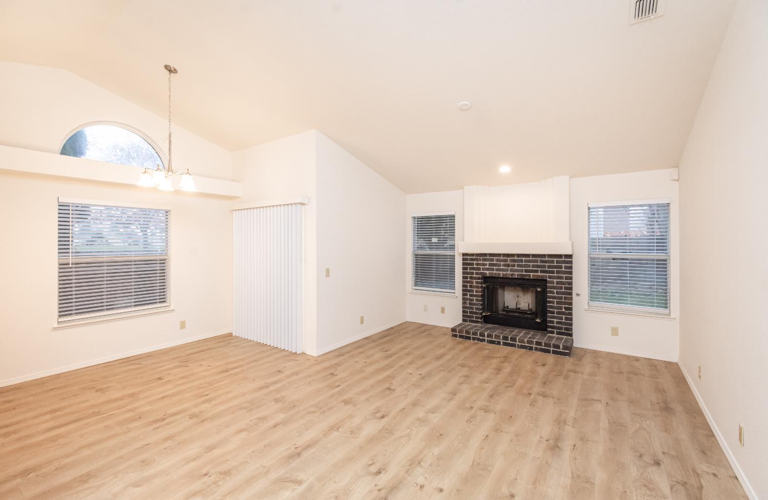 8245 Calleystone Way Antelope, CA 95843 - Photo 4 of 33 a view of empty room with fireplace and wooden floor