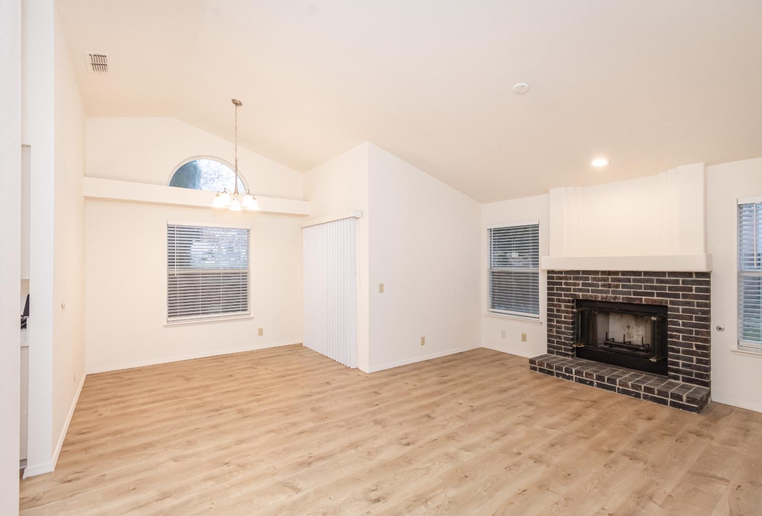 8245 Calleystone Way Antelope, CA 95843 - Photo 5 of 33 a view of empty room with fireplace and fan