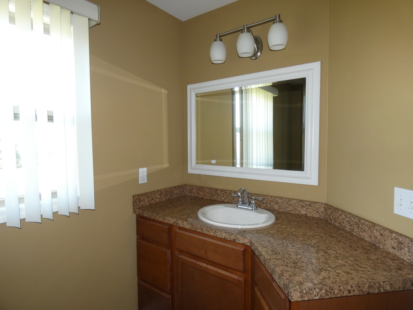 627 North Edgemere Drive Bourbonnais, IL 60914 - Photo 23 of 37 a bathroom with a sink and a mirror