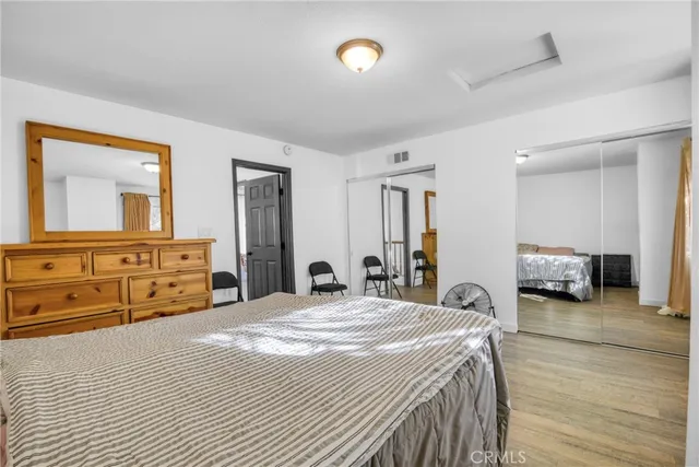 a bedroom with a bed and a mirror