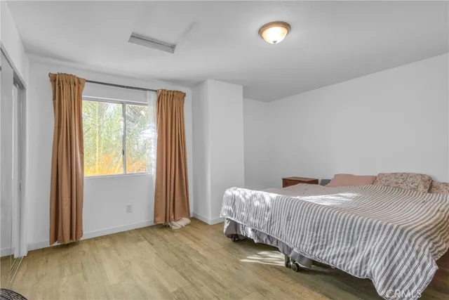 a bedroom with a bed and window
