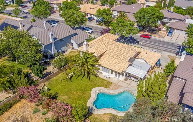 an aerial view of residential house with outdoor space and swimming pool