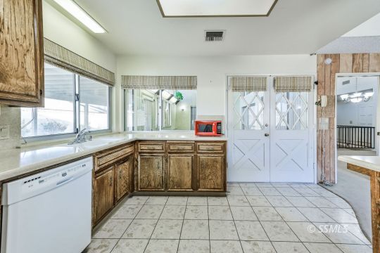 925 Scott Street Ridgecrest, CA 93555 - Photo 17 of 46 a large kitchen with a stove a sink dishwasher and a refrigerator