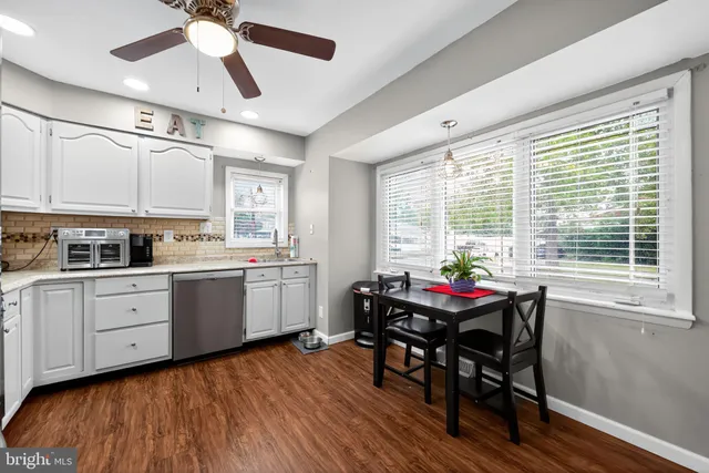 a kitchen with sink cabinets and dining table