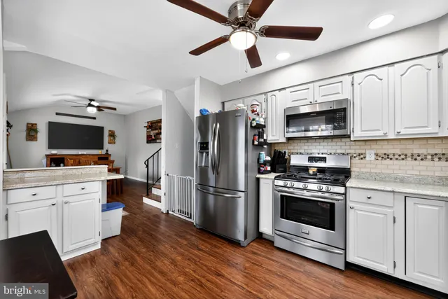 a kitchen with stainless steel appliances a stove microwave and a refrigerator