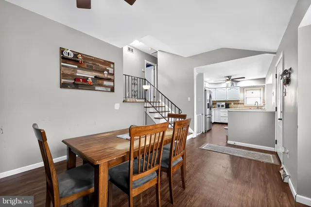 a dining room with furniture and wooden floor
