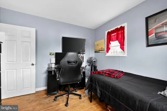 a view of a workspace with furniture and wooden floor