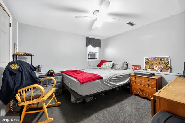 a bedroom with two beds and a desk