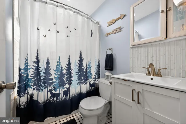 a living room with furniture and floor to ceiling window