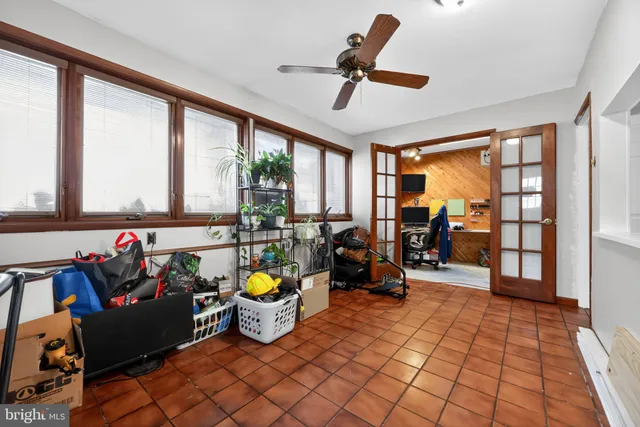 a very nice looking room with many windows and furniture