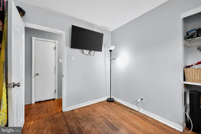 a view of a livingroom with a wooden floor and a flat screen tv