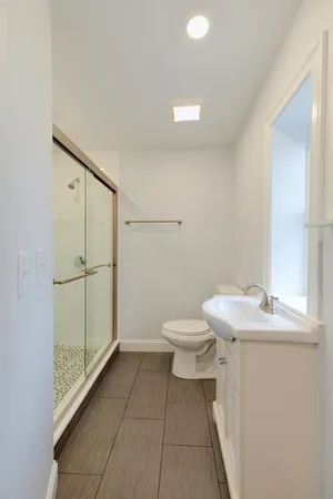 a bathroom with a sink a toilet and a shower