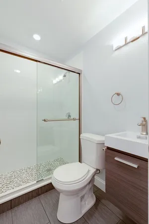 a bathroom with a toilet a sink and shower