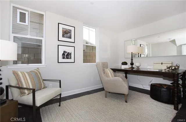 a living room with furniture and painting on the wall
