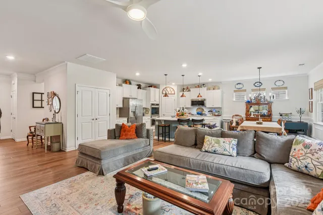 a living room with furniture ceiling fan and a flat screen tv