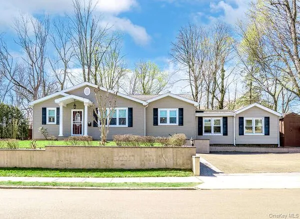 a front view of a house with a yard table and chairs