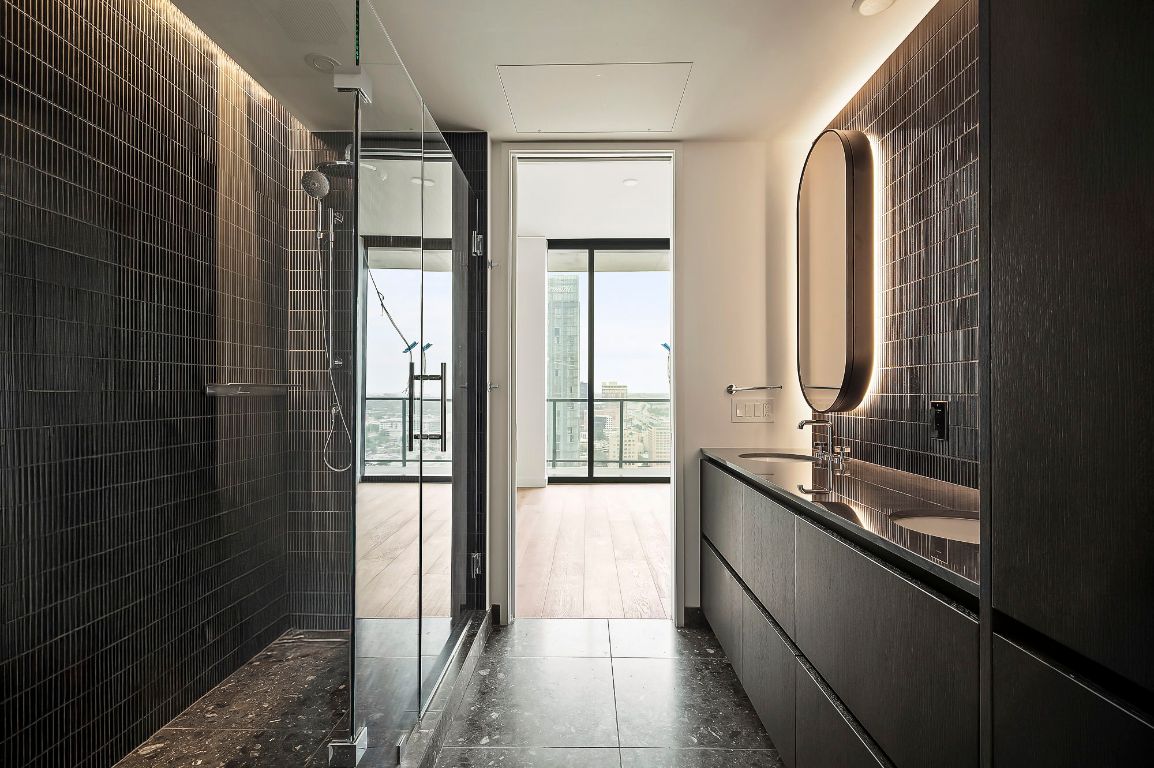 610 Davis Street, Unit 2812 Austin, TX 78701 - Photo 11 of 32 a bathroom with a granite countertop sink a toilet and shower
