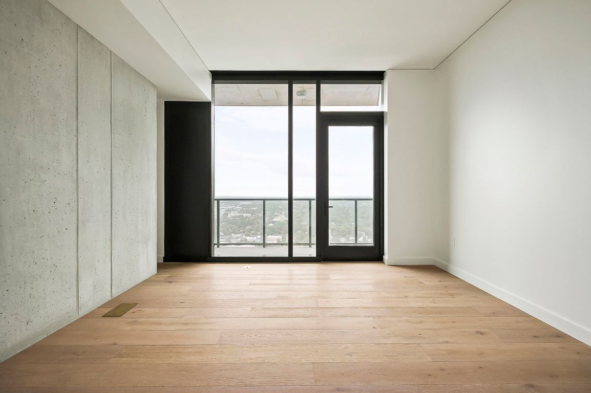 610 Davis Street, Unit 2812 Austin, TX 78701 - Photo 16 of 32 a view of an empty room with wooden floor and a window
